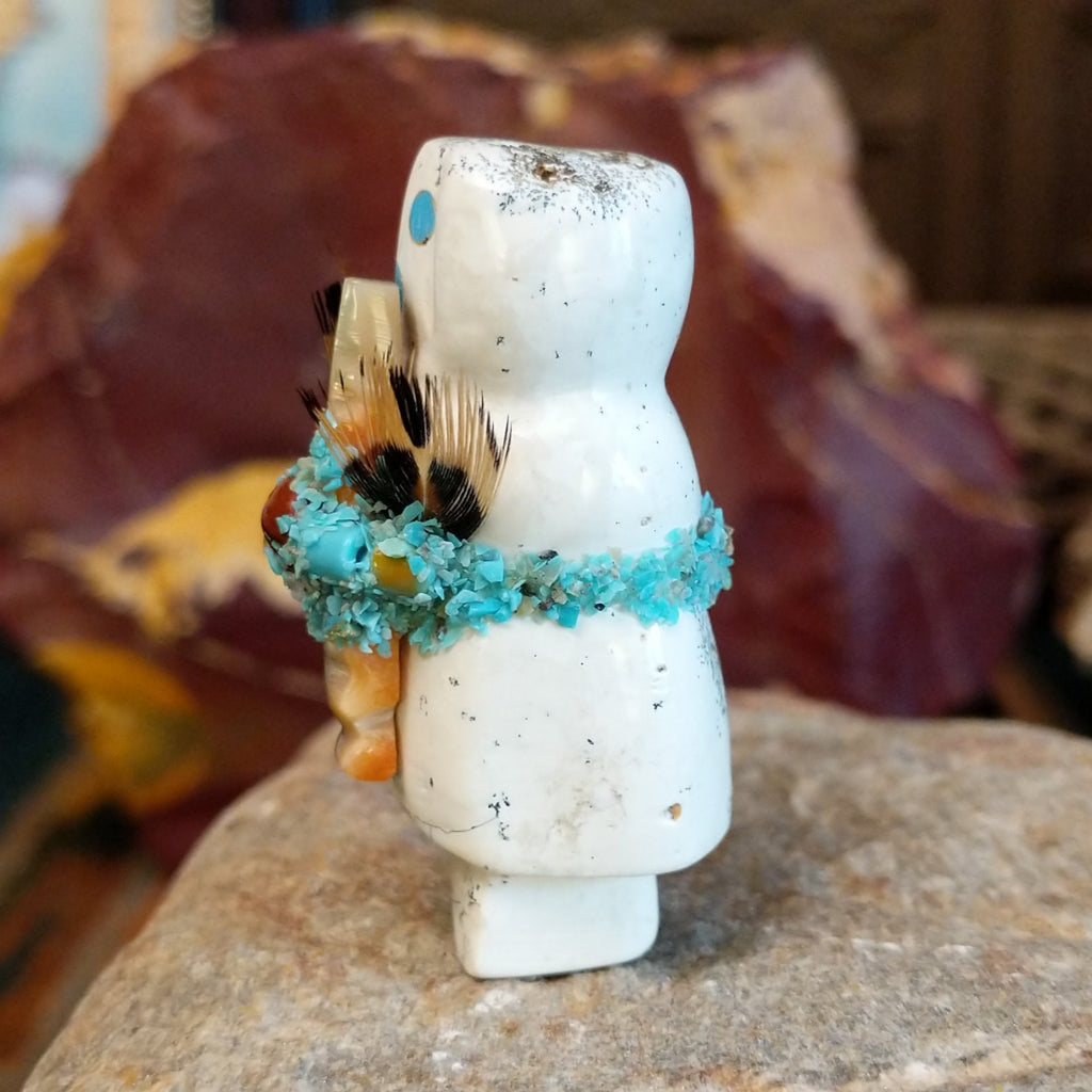 Serpentine carved into an altar doll fetish holding feathers, and turquoise clusters looping around the body.