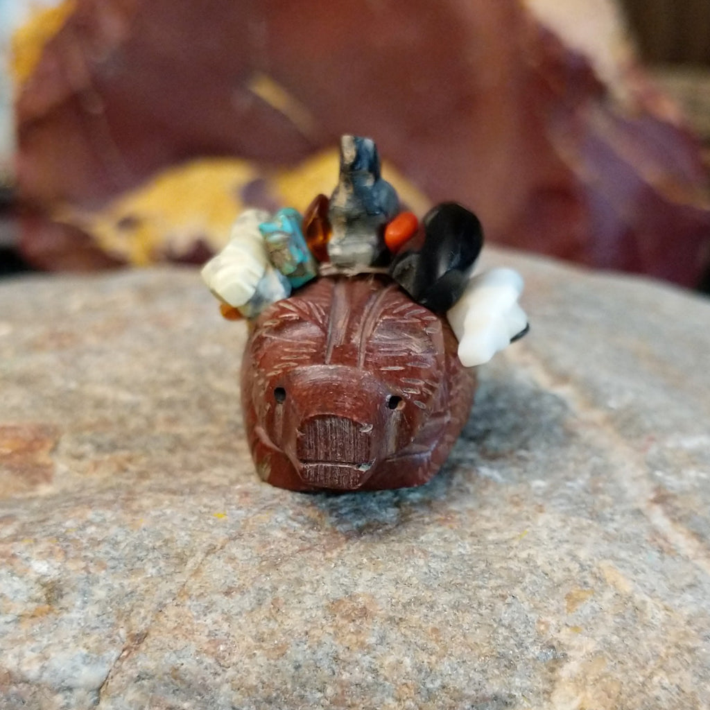 Badger carved from pipestone with various other fetishes atop its back carved from various semi-precious stones.