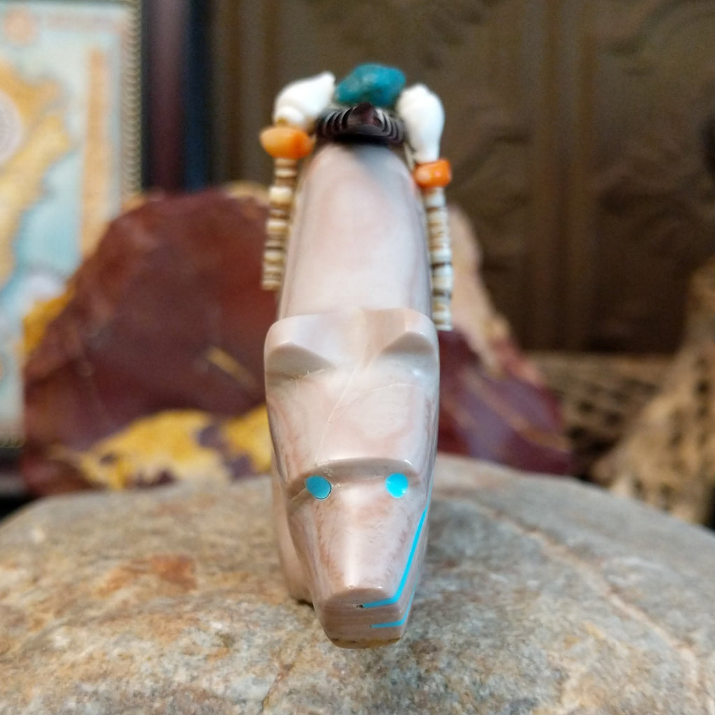 Banded dolomite carved into a bear with turquoise arrows inlaid on the body and pen shell and various stones beaded along its' torso.