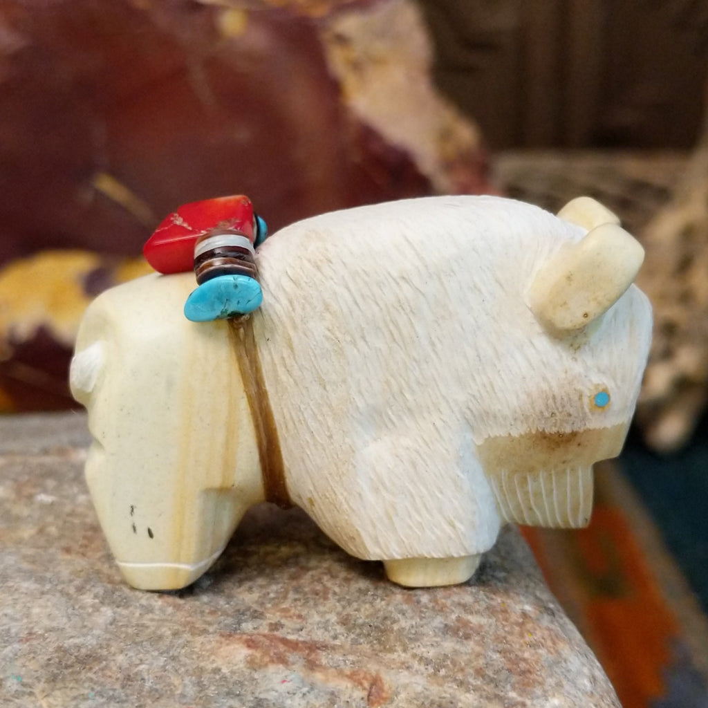 Utah sandstone carved into a bison with turquoise, coral, and pen shell beaded on it's back.