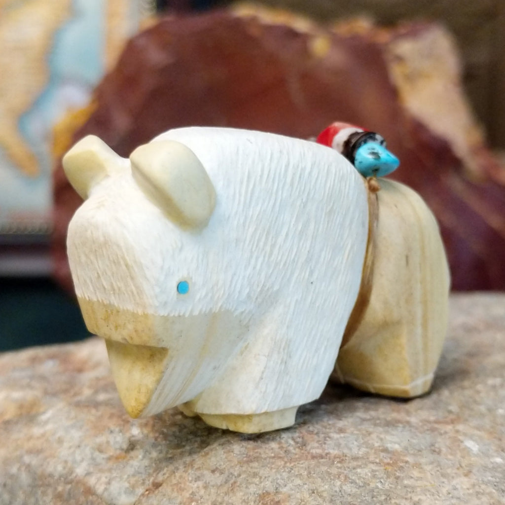 Utah sandstone carved into a bison with turquoise, coral, and pen shell beaded on it's back.