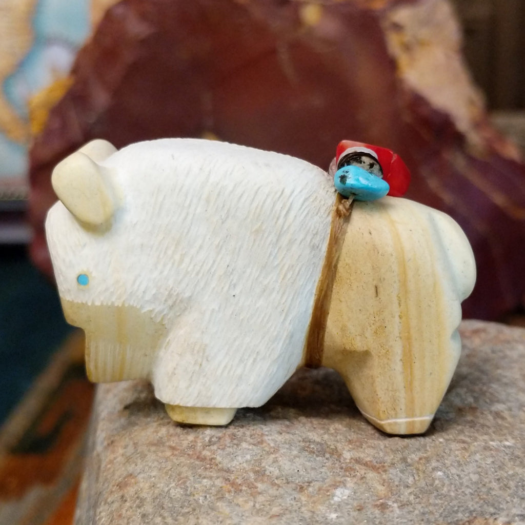 Utah sandstone carved into a bison with turquoise, coral, and pen shell beaded on it's back.