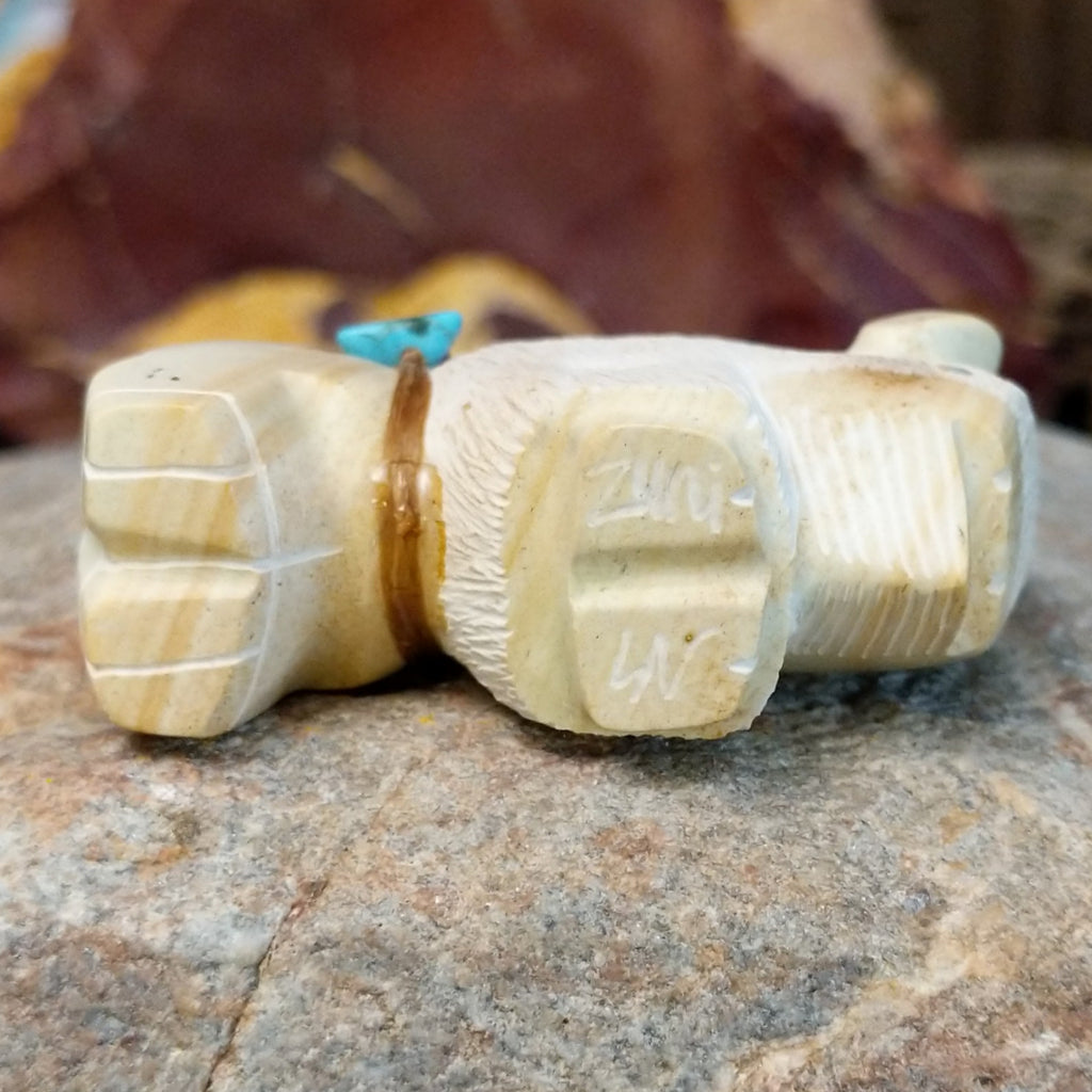 The artisan's signature is found on the underside of the piece.