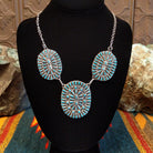Sterling silver necklace with needlepoint clusters set on three conchos, and the turquoise set in notched bezels.