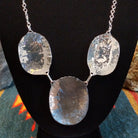 Sterling silver necklace with needlepoint clusters set on three conchos, and the turquoise set in notched bezels.