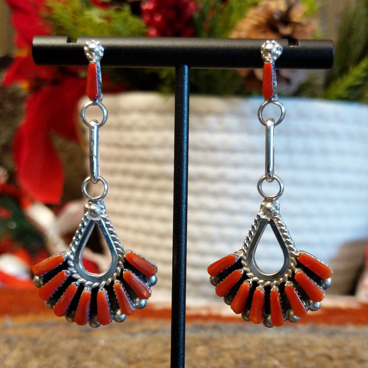 Coral set in bezels that form a chandelier and are set on dangle posts.