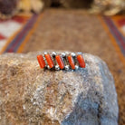 Sterling silver ring with coral set in five narrow bezels.