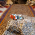 Sterling silver ring with coral set in five narrow bezels.