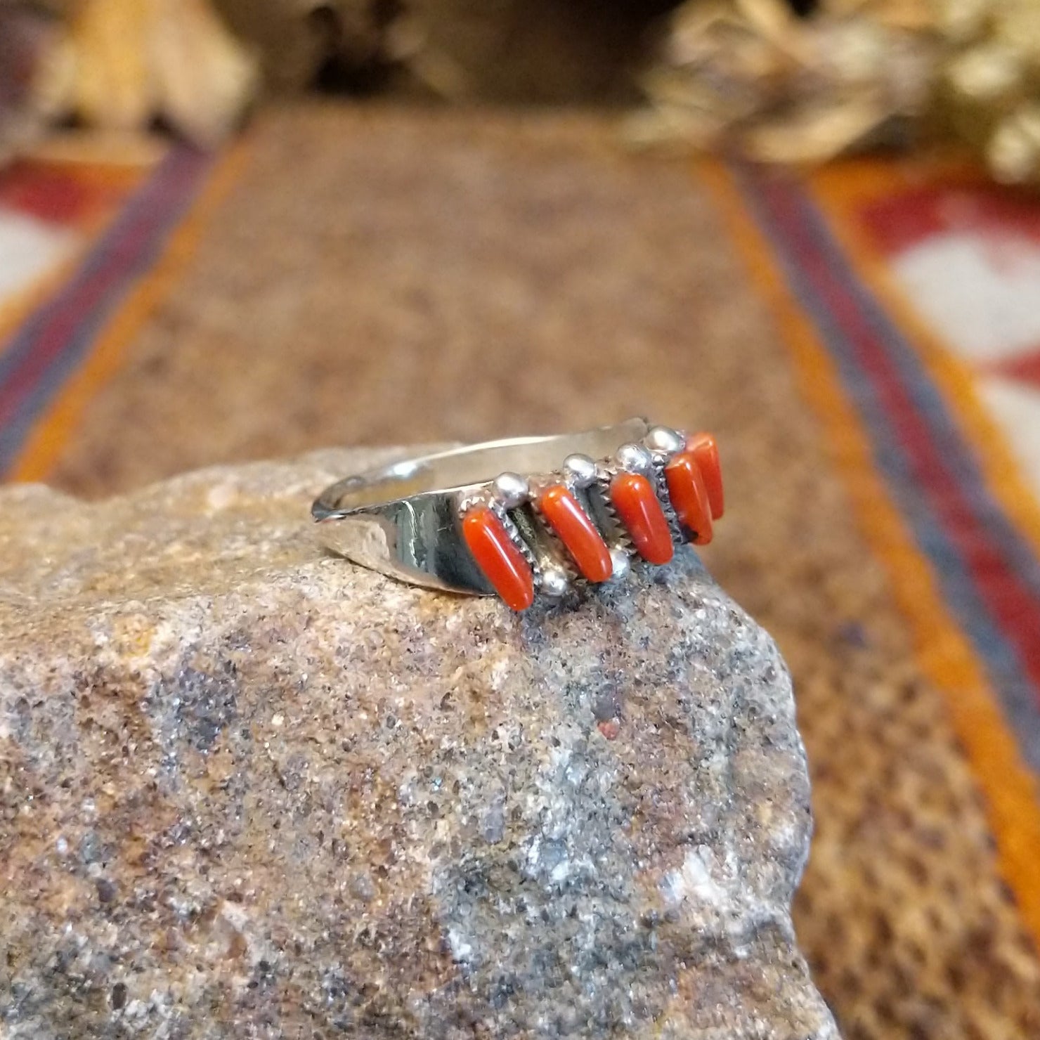 Sterling silver ring with coral set in five narrow bezels.