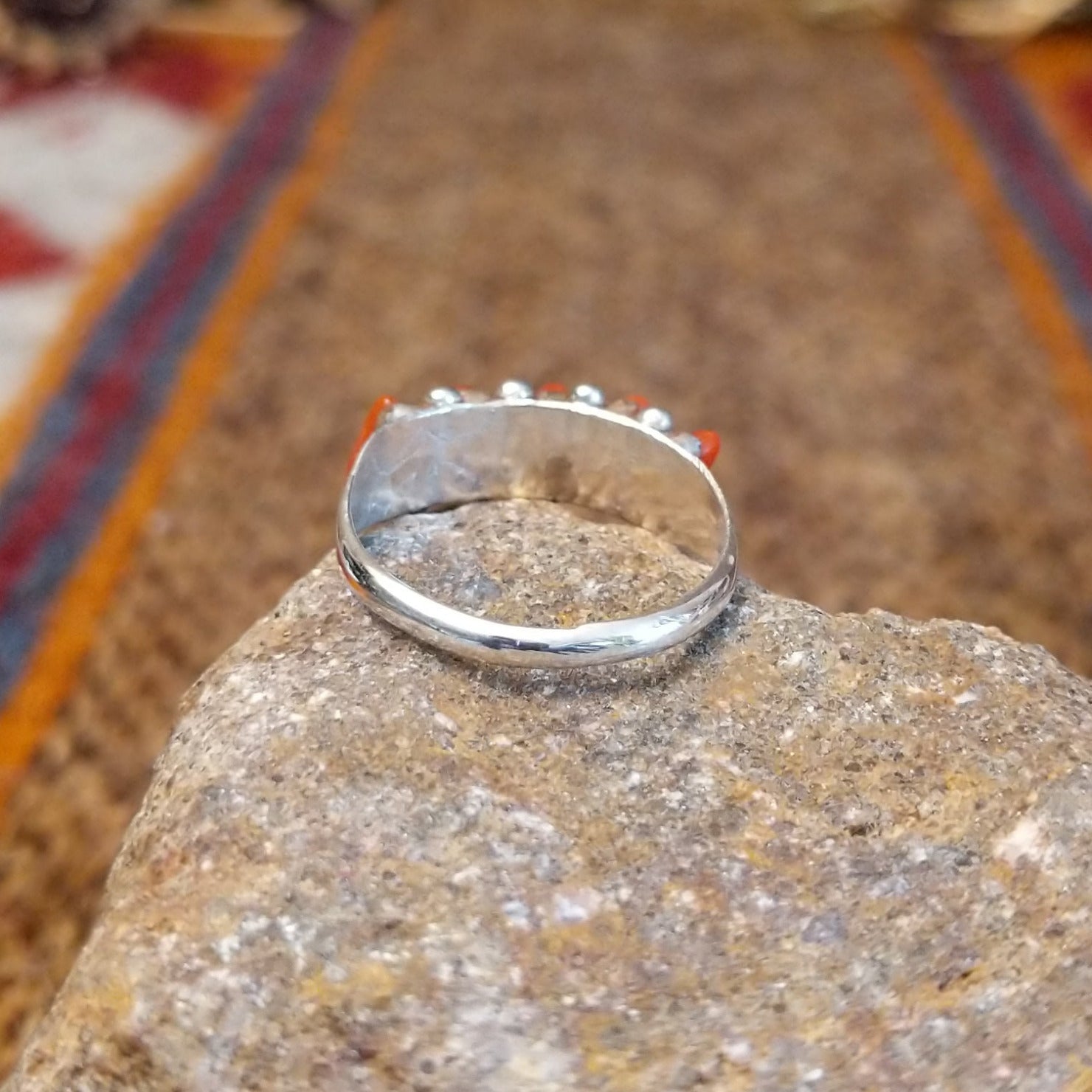 Sterling silver ring with coral set in five narrow bezels.
