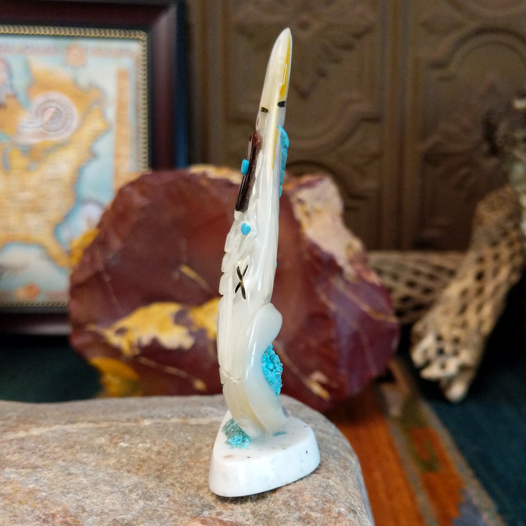 Zuni corn maiden fetish made from mother of pearl with turquoise accents along the body.