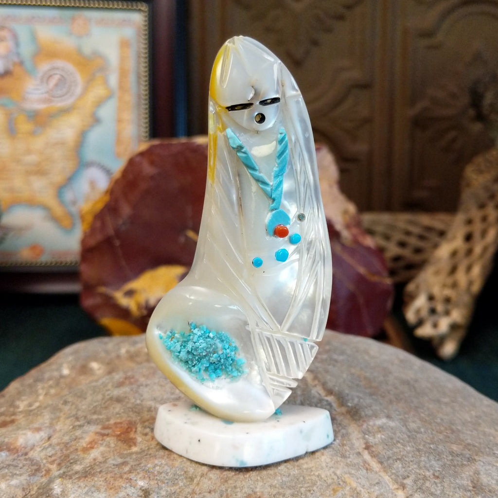 Zuni corn maiden fetish made from mother of pearl with turquoise accents along the body.