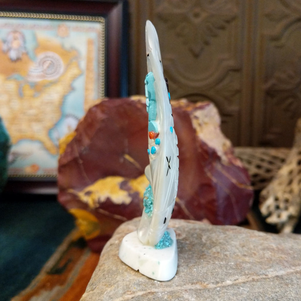 Zuni corn maiden fetish made from mother of pearl with turquoise accents along the body.