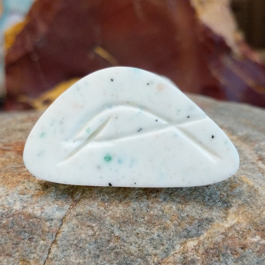 The underside of the piece features the artisan's signature.