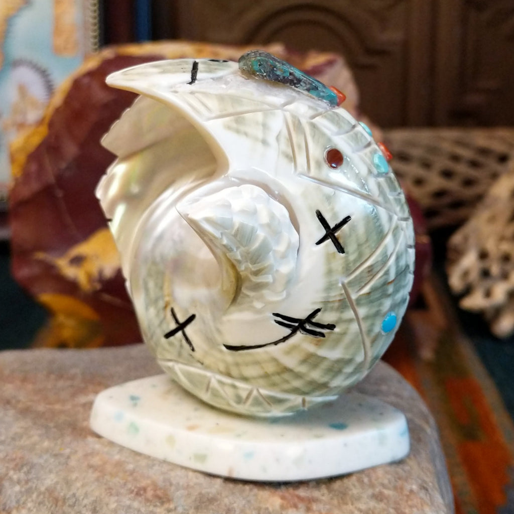 Green snail shell carved as a corn maiden along the shell with small turquoise beads.