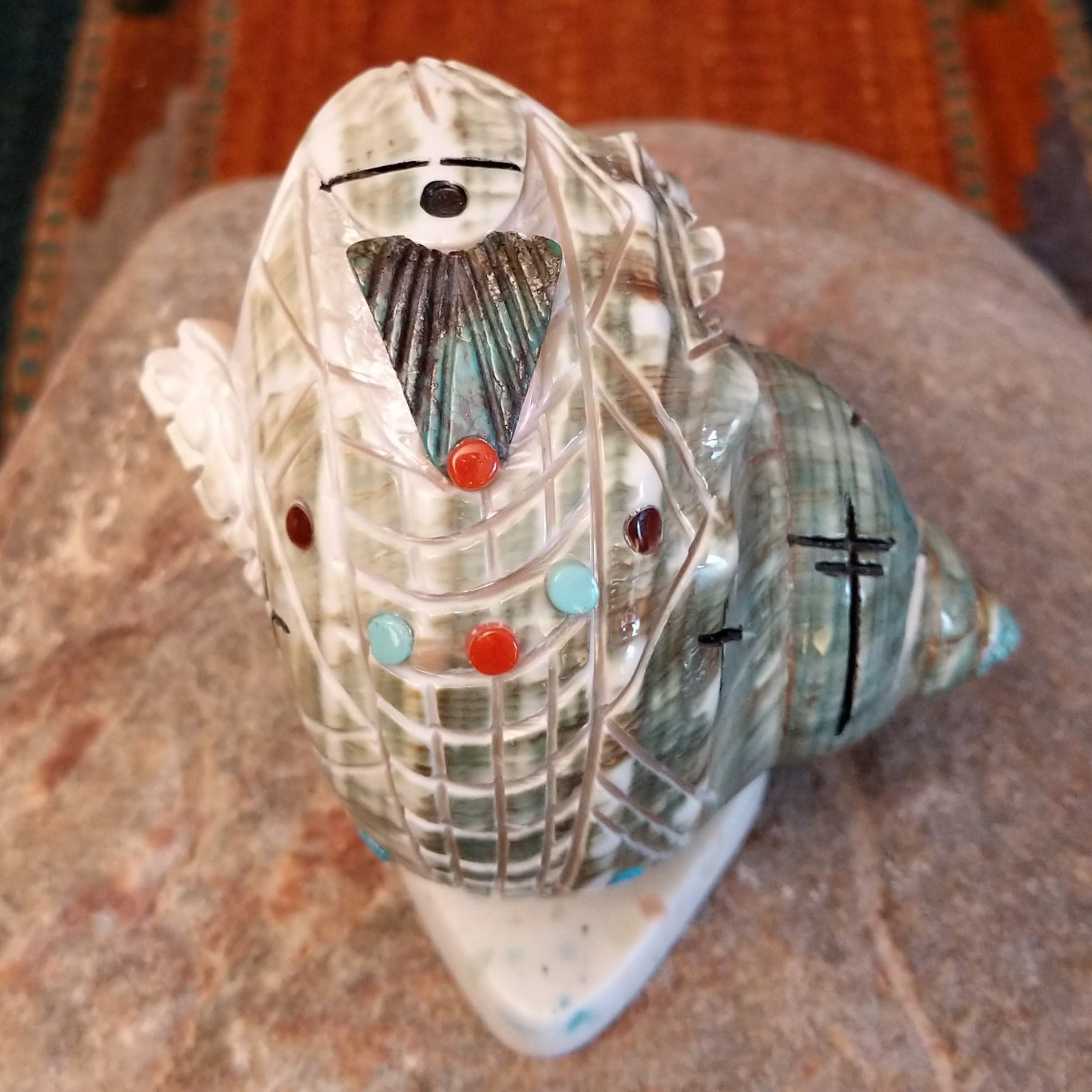 Green snail shell carved as a corn maiden along the shell with small turquoise beads.