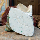 The artisan's signature is found at the bottom of the shell.