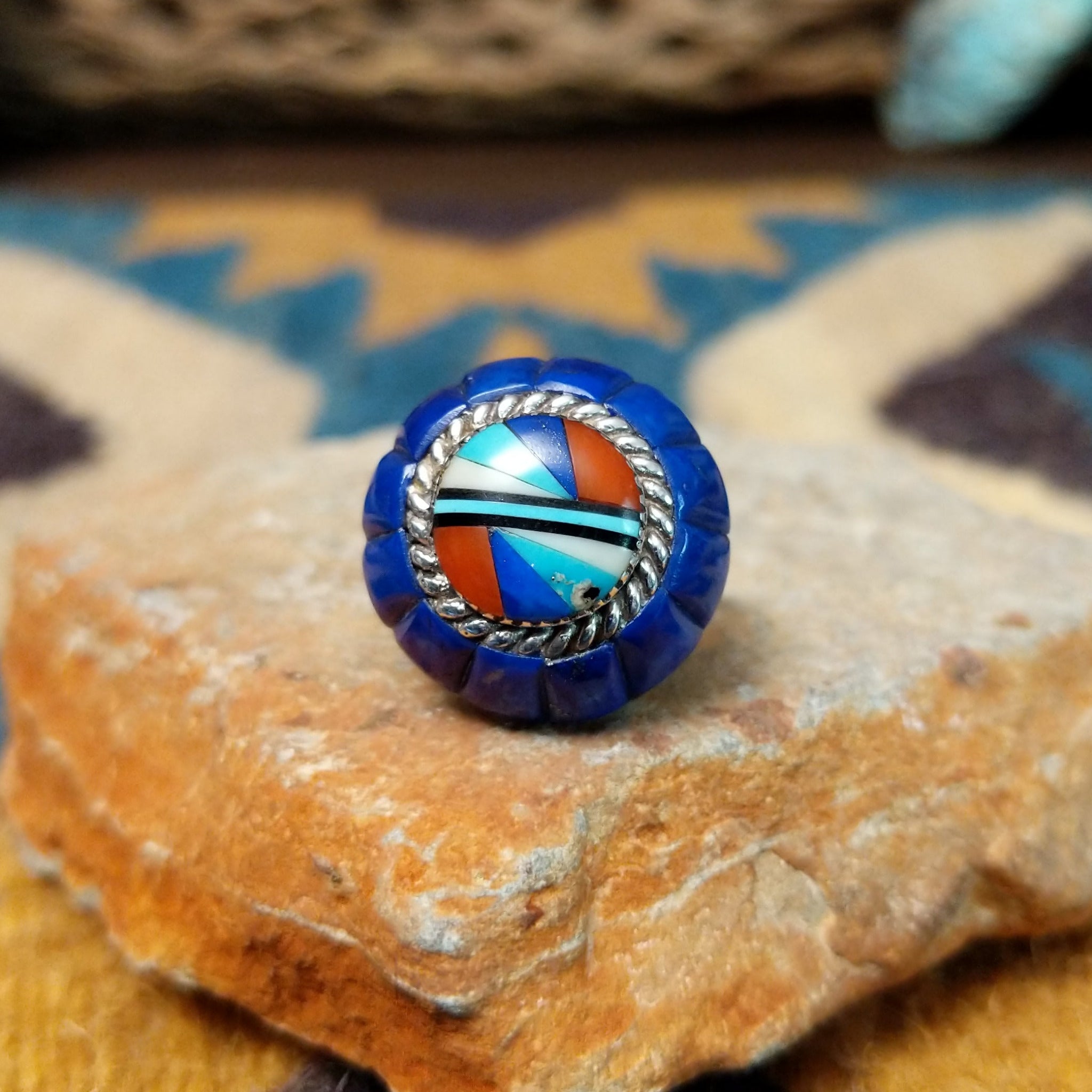 Handcrafted sterling silver Zuni dome ring by Lee & Mary Weebothee, featuring a colorful Sunface-inspired multistone inlay surrounded by lapis.