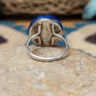 Handcrafted sterling silver Zuni dome ring by Lee & Mary Weebothee, featuring a colorful Sunface-inspired multistone inlay surrounded by lapis; underside view.