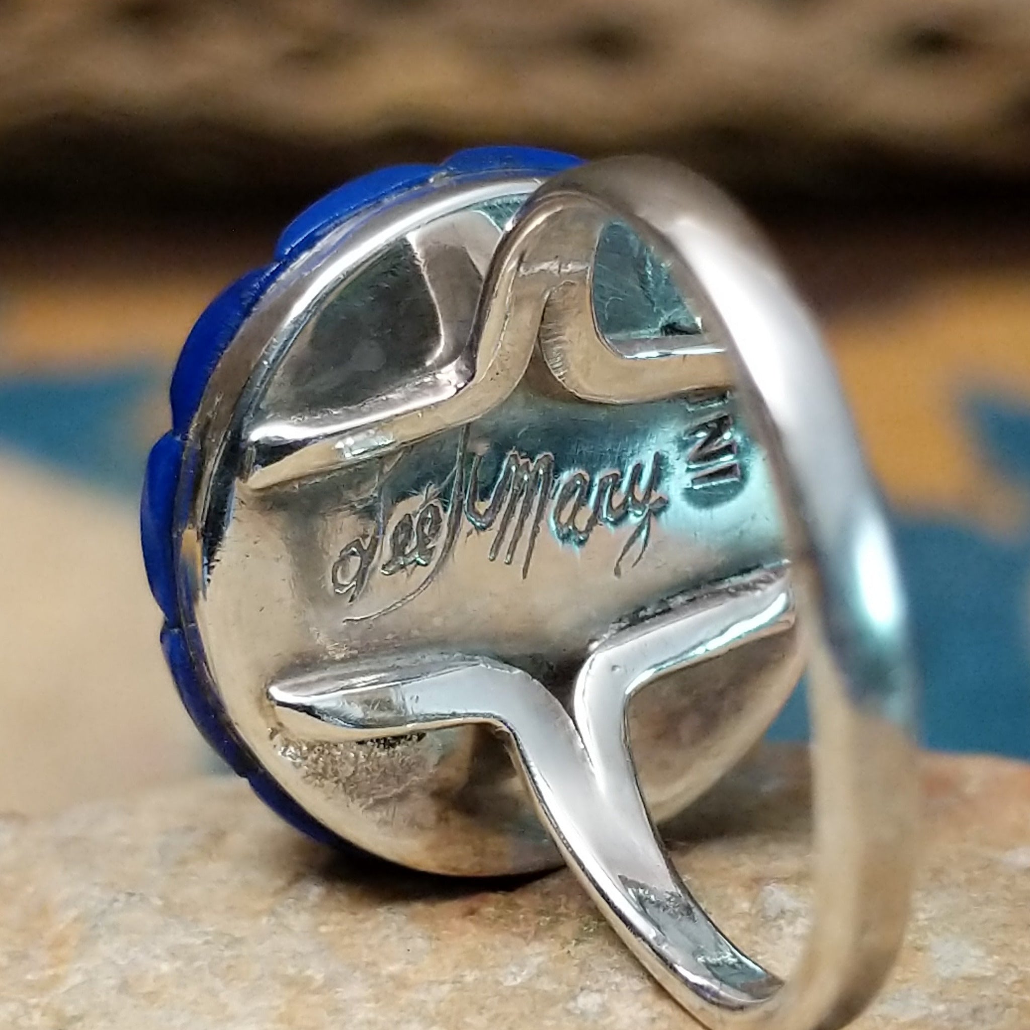 Handcrafted sterling silver Zuni dome ring by Lee & Mary Weebothee, featuring a colorful Sunface-inspired multistone inlay surrounded by lapis; artisan and Sterling Silver stamp.