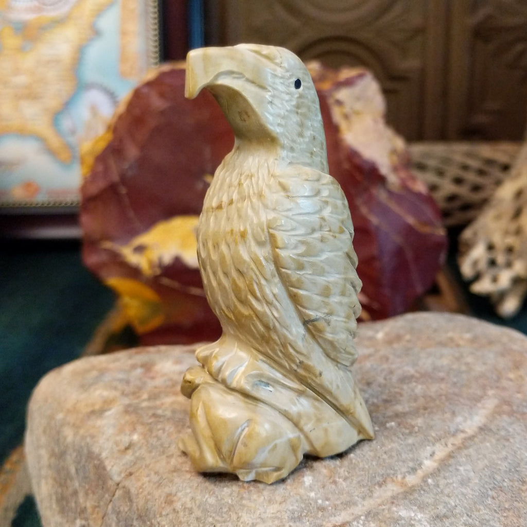 Alabaster carved into an eagle fetish with intricate detailing and a rabbit caught in its' talons.