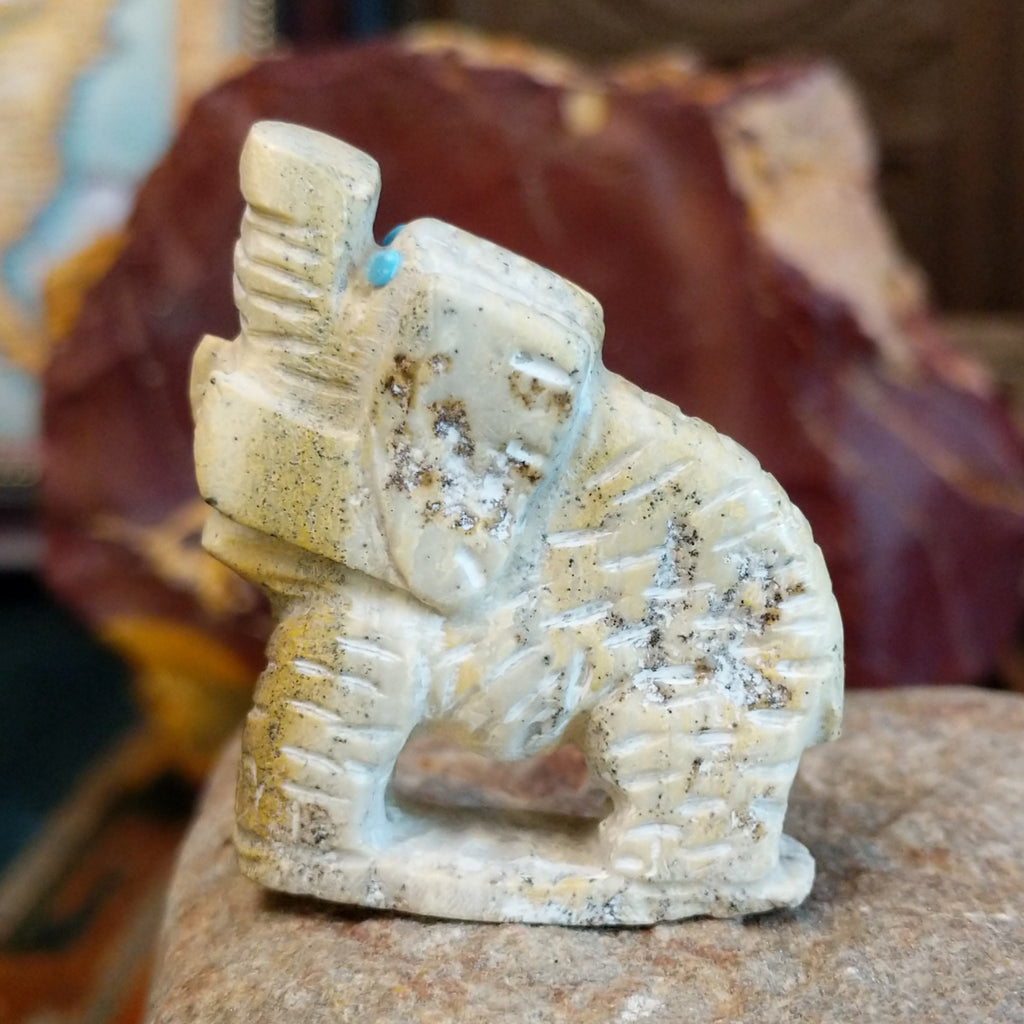 Serpentine carved into an elephant fetish with intricate carved details along its' body.