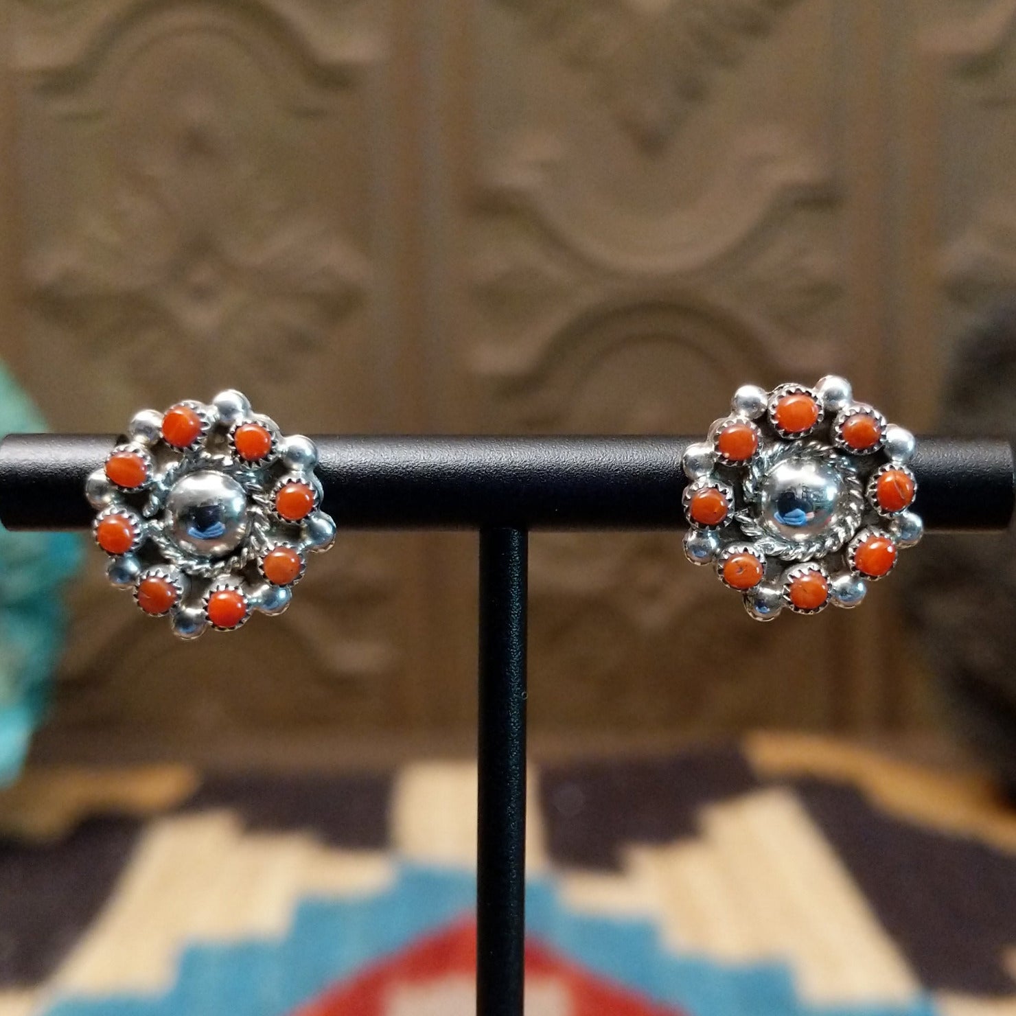 Sterling silver earrings with coral set in notched bezels. 