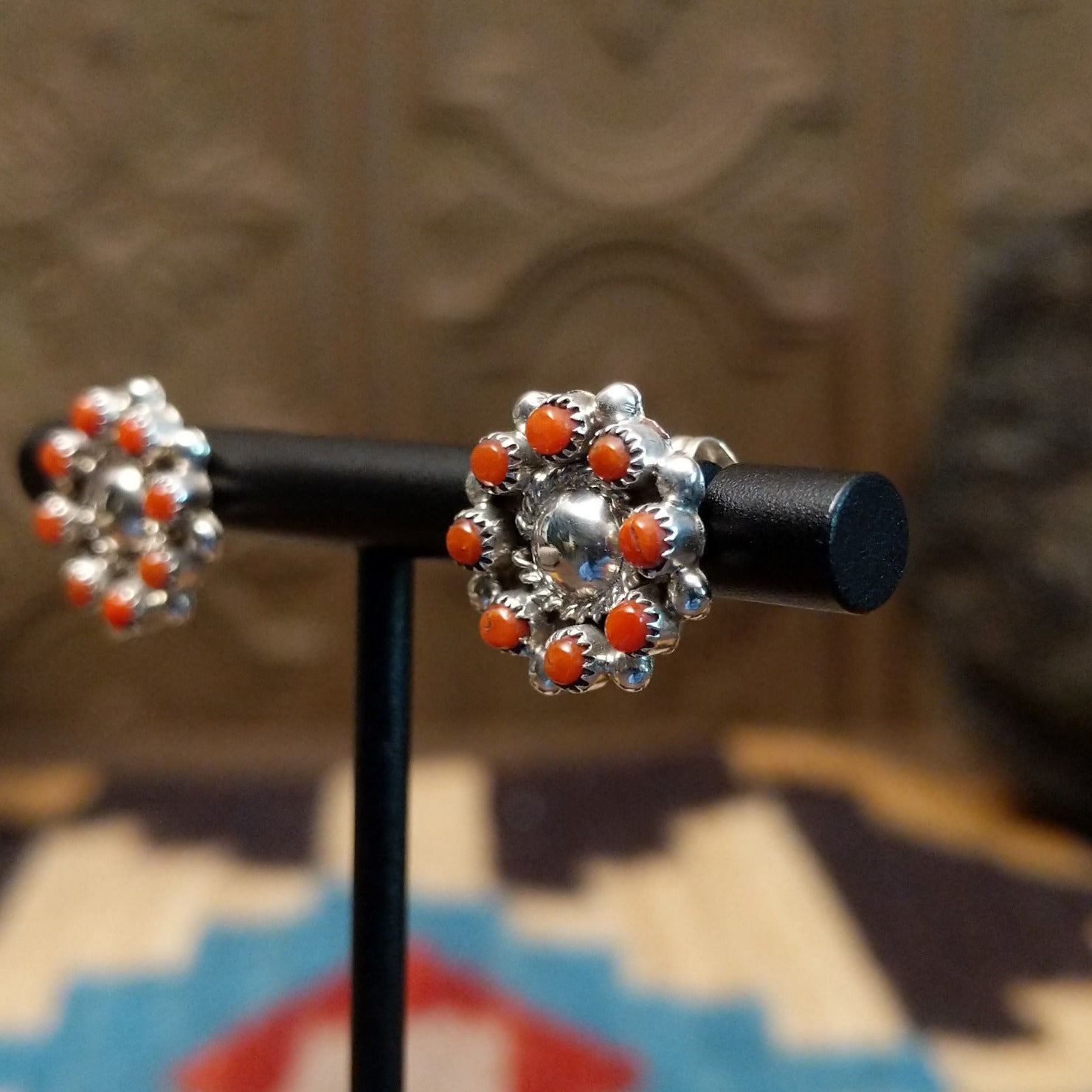 Sterling silver earrings with coral set in notched bezels. 