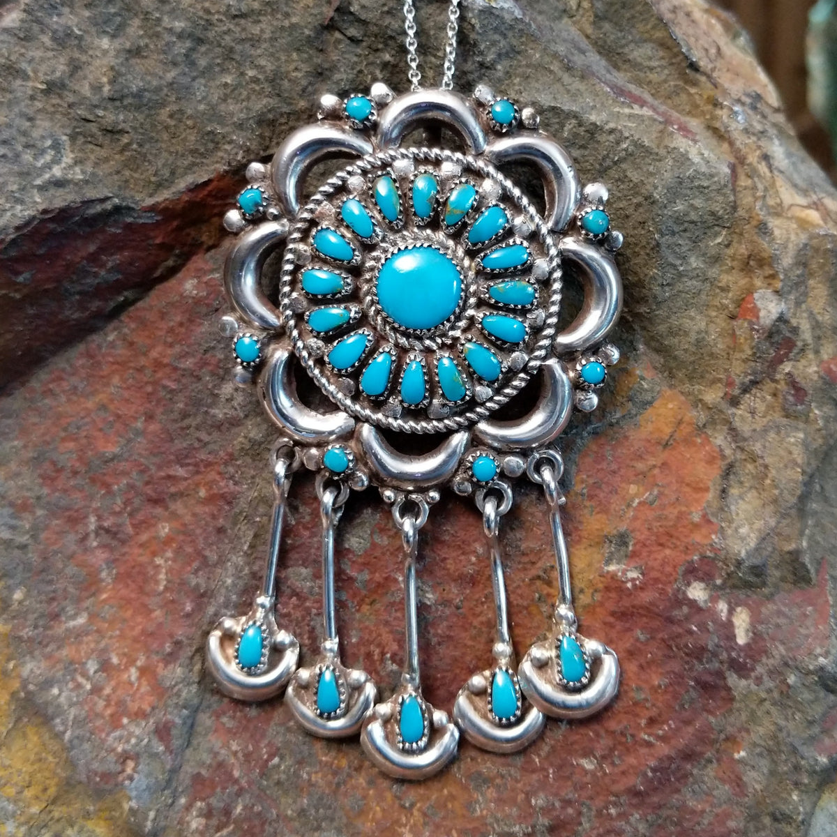 Zuni turquoise dangle pendant and pin by Lorraine Waatsa featuring a floral turquoise cluster, polished silver loops, twisted-wire detailing, and five turquoise-accented dangles.