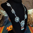 Sterling silver necklace with floral settings and turquoise set in the bezels.