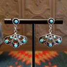 Sterling silver earrings with floral settings and turquoise set in the bezels.