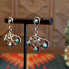 Sterling silver earrings with floral settings and turquoise set in the bezels.