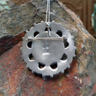 Zuni turquoise pendant and pin by Lorraine Waatsa featuring a floral cluster of turquoise stones surrounded by polished silver loops, twisted wire, and silver bead detailing; artisan and tribe stamp.