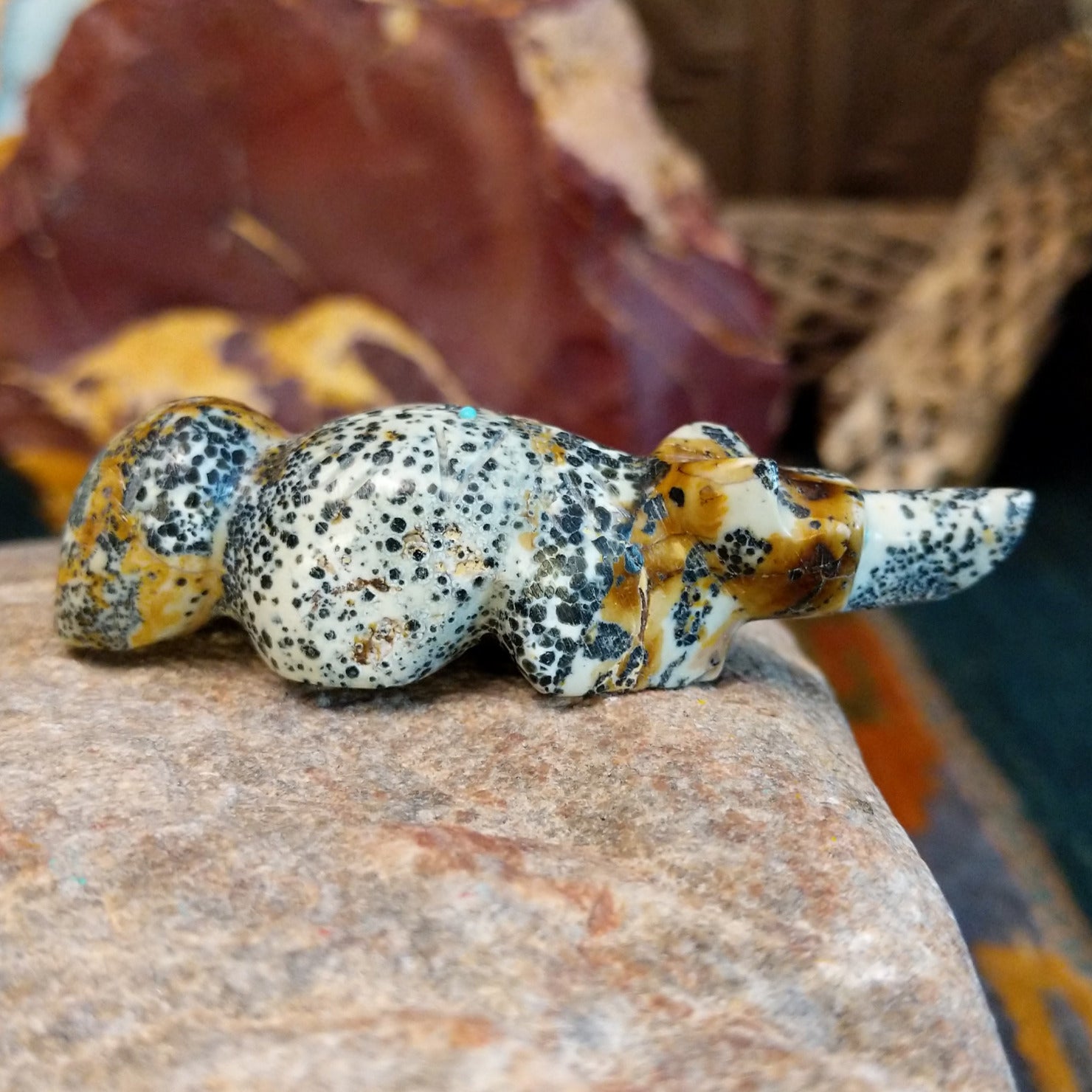 Spotted serpentine carved into a fox fetish with various matrix along the body.