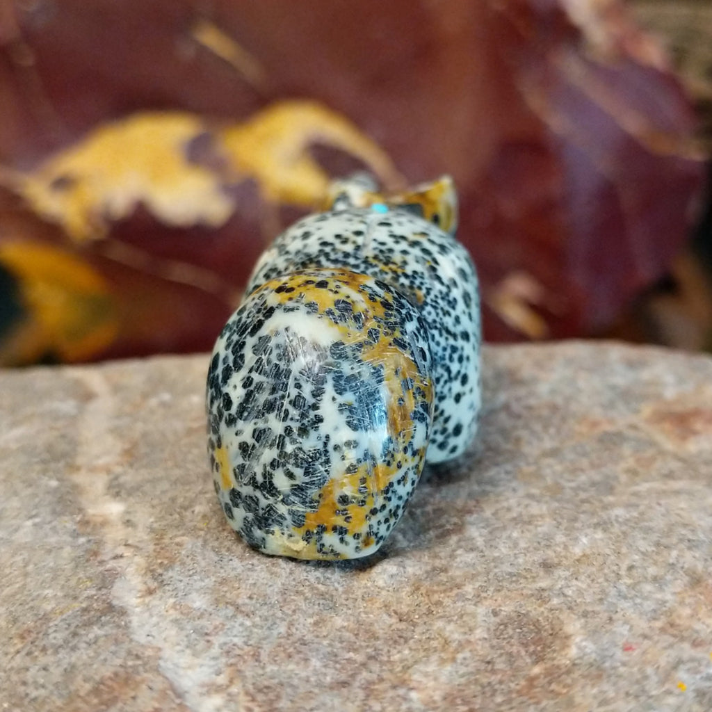 Spotted serpentine carved into a fox fetish with various matrix along the body.