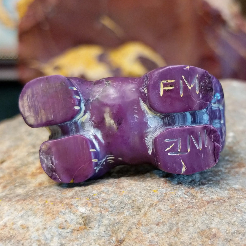 The artisan's signed initials on the bottom of the piece.