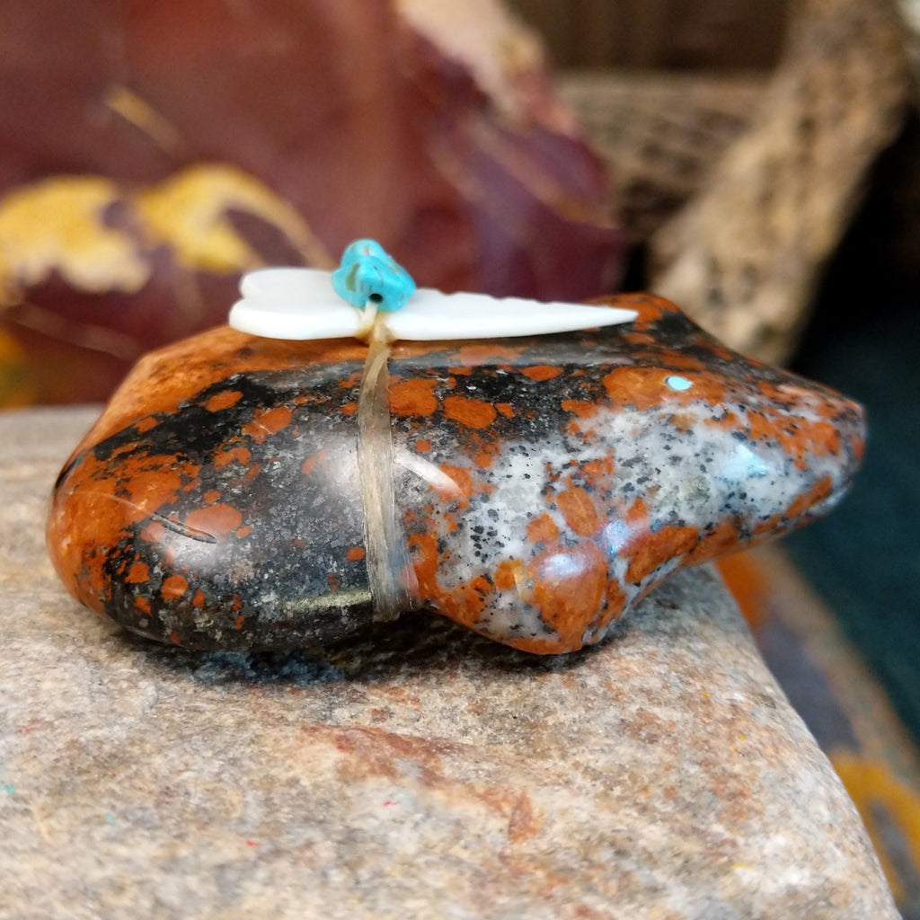 Brown and black matrix stone carved into a frog fetish with turquoise and mother of pearl tied to its' back.