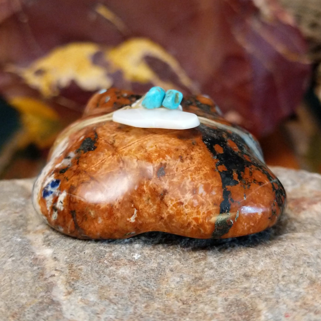 Brown and black matrix stone carved into a frog fetish with turquoise and mother of pearl tied to its' back.