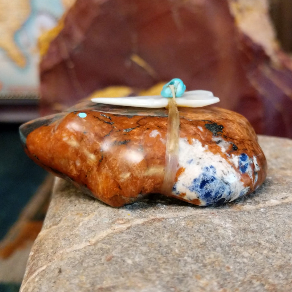 Brown and black matrix stone carved into a frog fetish with turquoise and mother of pearl tied to its' back.