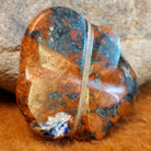 The artisan's initials are carved into the underside of the piece.