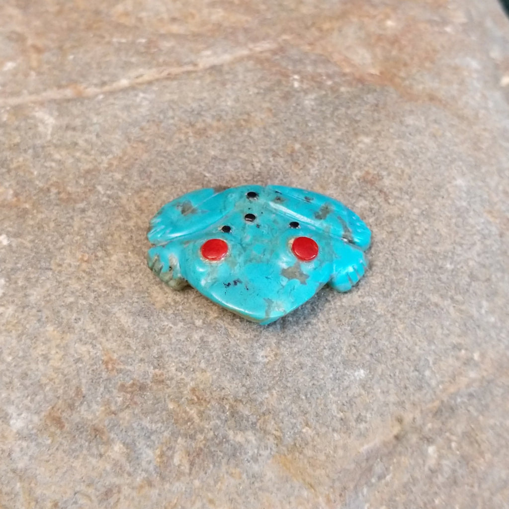 Frog carving made of turquoise with coral eyes and black onyx spots.