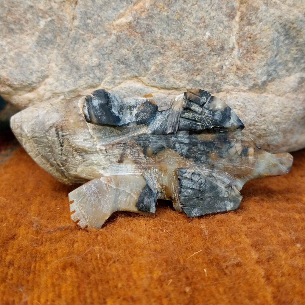 The underside of the piece showcases the intricate matrix of the picasso marble.