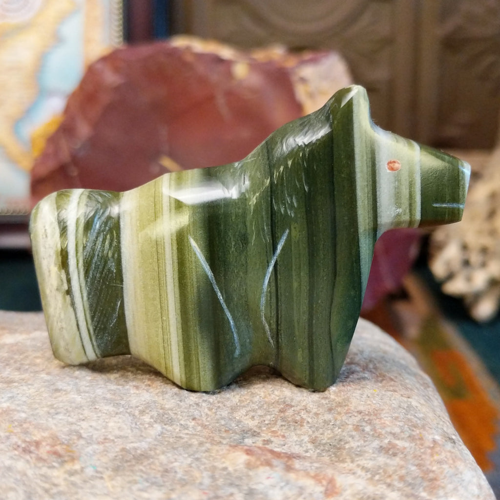 Ricolite carved into a horse fetish with green banding and etched details.