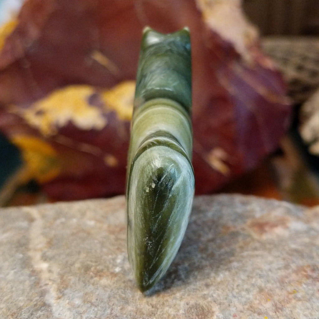 Ricolite carved into a horse fetish with green banding and etched details.