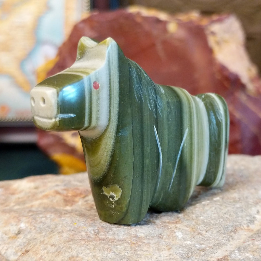 Ricolite carved into a horse fetish with green banding and etched details.