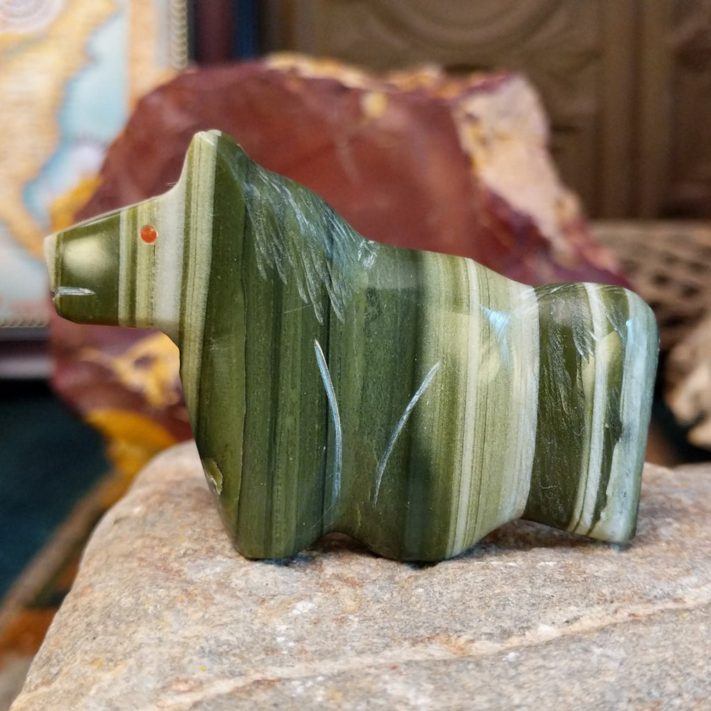 Ricolite carved into a horse fetish with green banding and etched details.