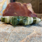 The artisan's signature is found on the underside of the piece.