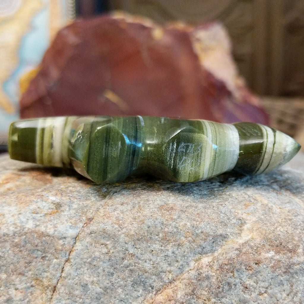 The artisan's signature is found on the underside of the piece.