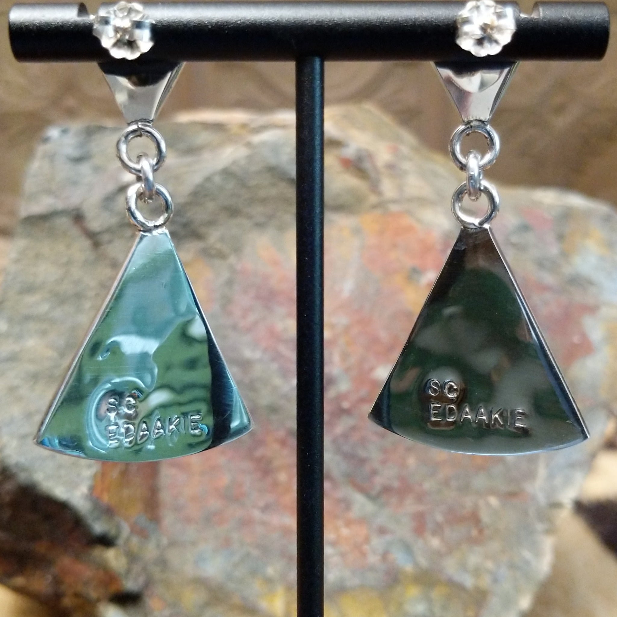Handcrafted sterling silver Zuni hummingbird inlay earrings by Sanford Edaakie, featuring a two-piece dangle design with colorful flowers and hummingbirds; artisan stamp.