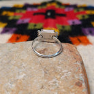 This colorful Zuni Inlay Ring features rectangular turquoise, black, and reddish-orange stone inlay in a geometric pattern, framed in silver with beaded accents along the sides; underside view.